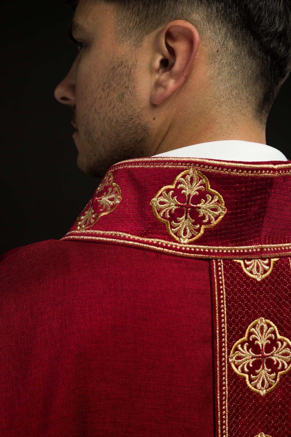 Red chasuble collar close-up with gold embroidery