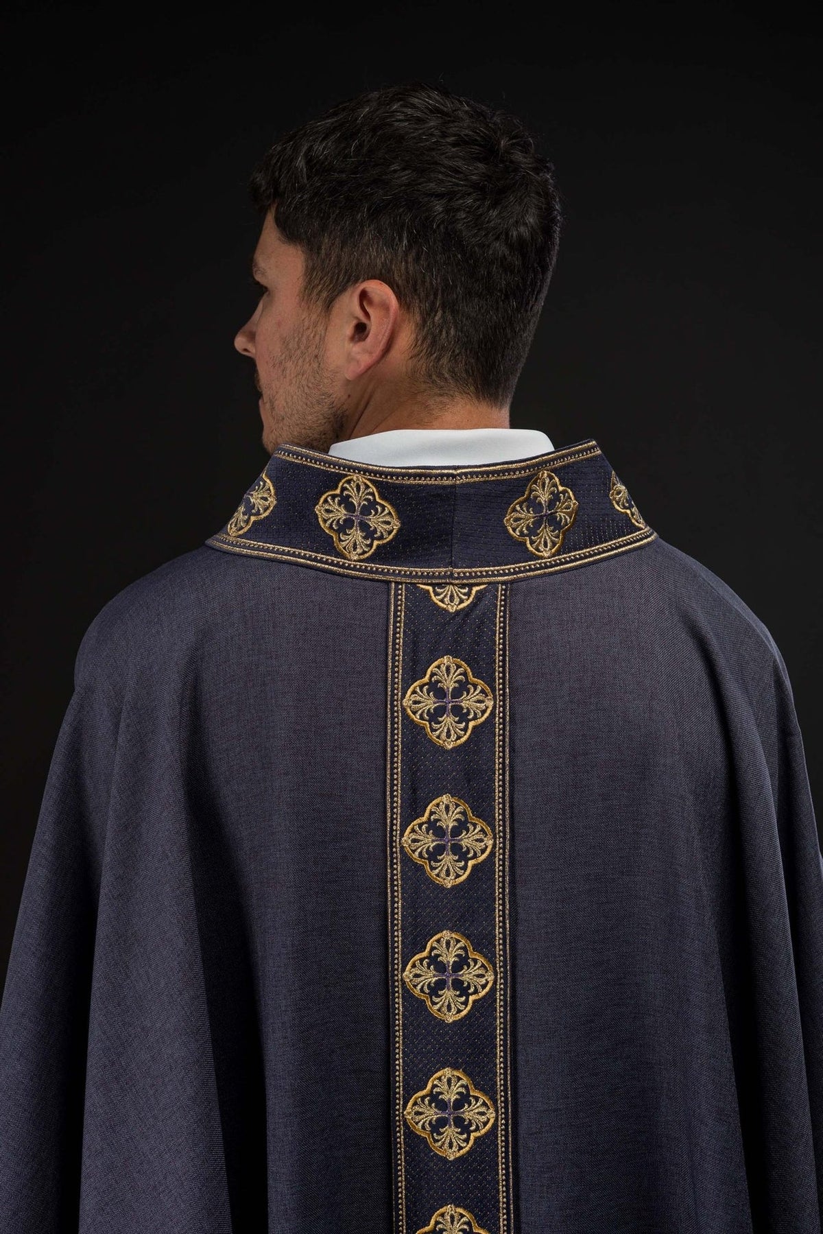 Purple chasuble back view with gold embroidered orphrey and collar