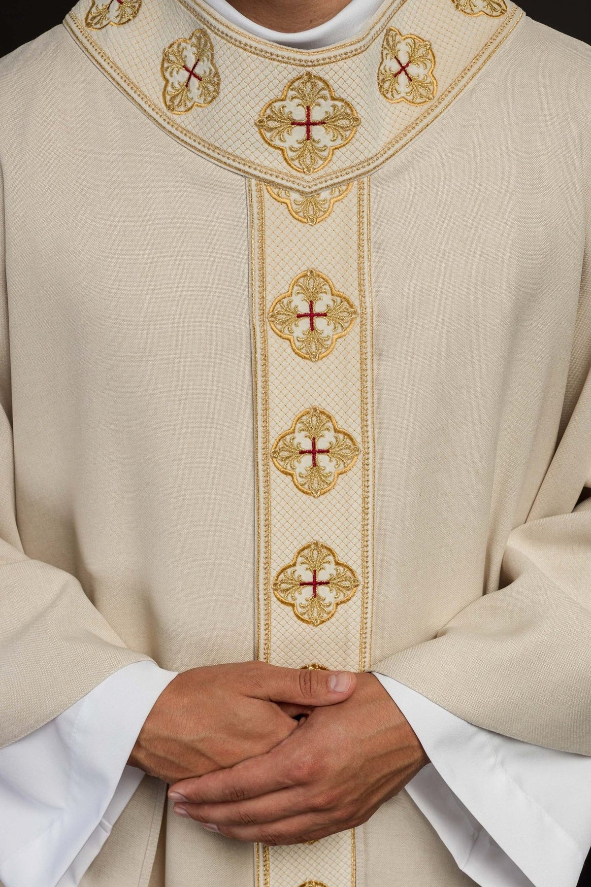 Ecru chasuble close-up showing gold embroidery and cross motifs