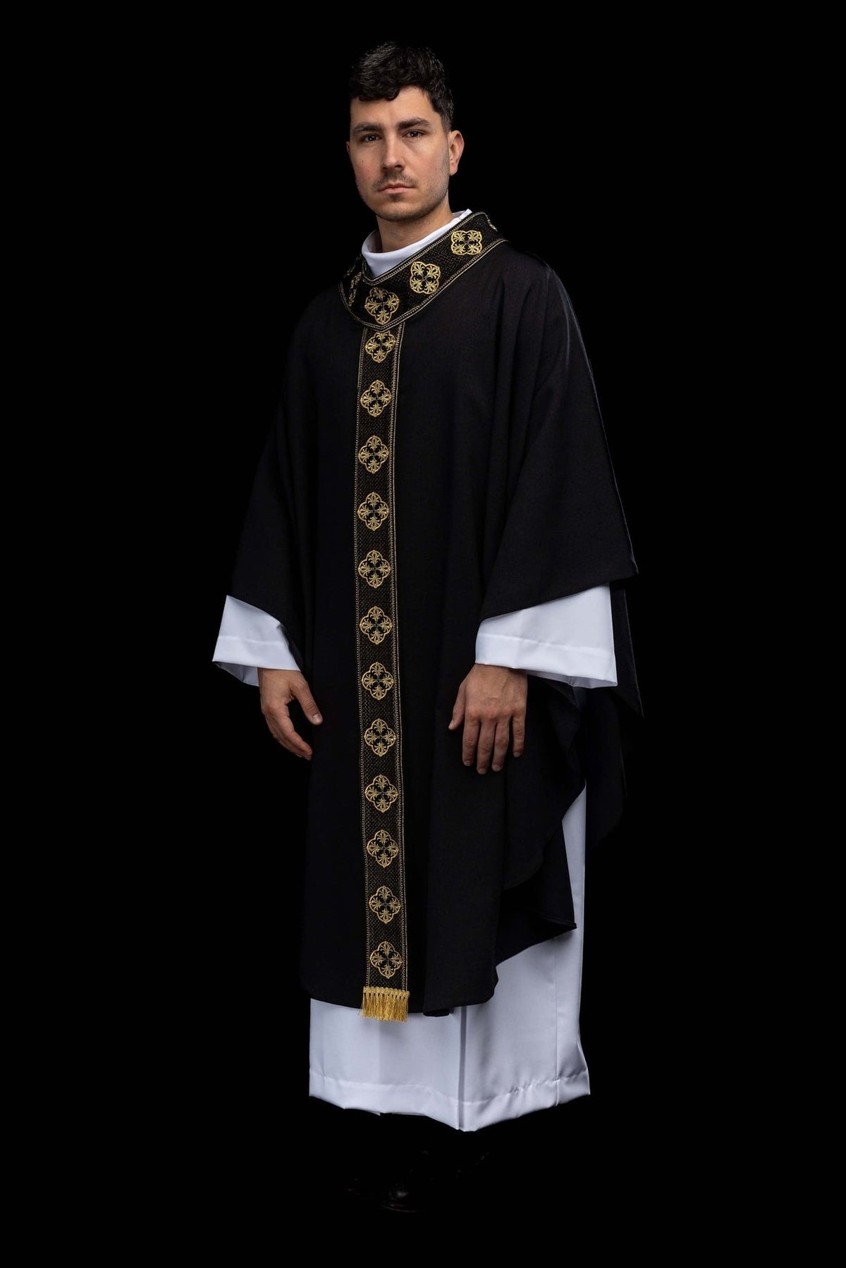 Black chasuble three-quarter front view with gold embroidered orphrey