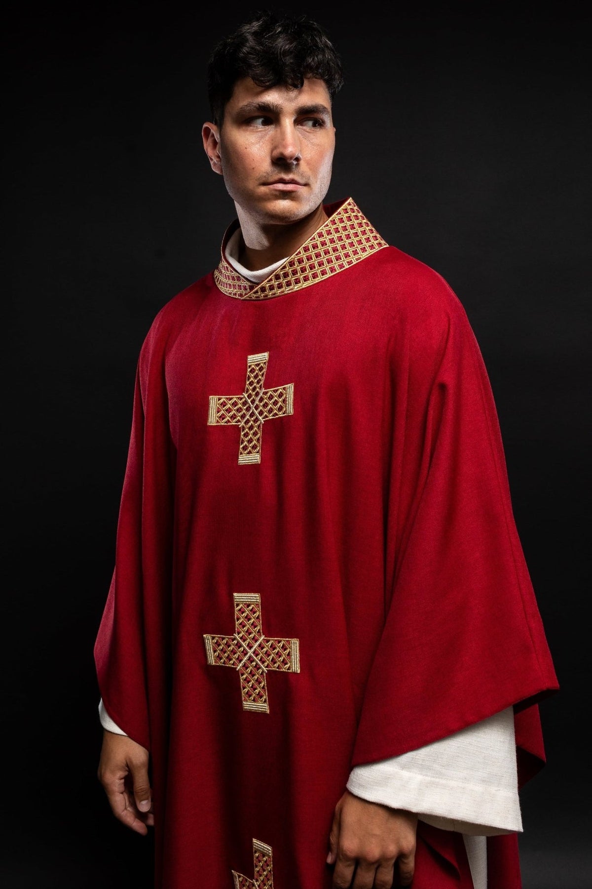 Red chasuble, angled front view with gold embroidered crosses and collar