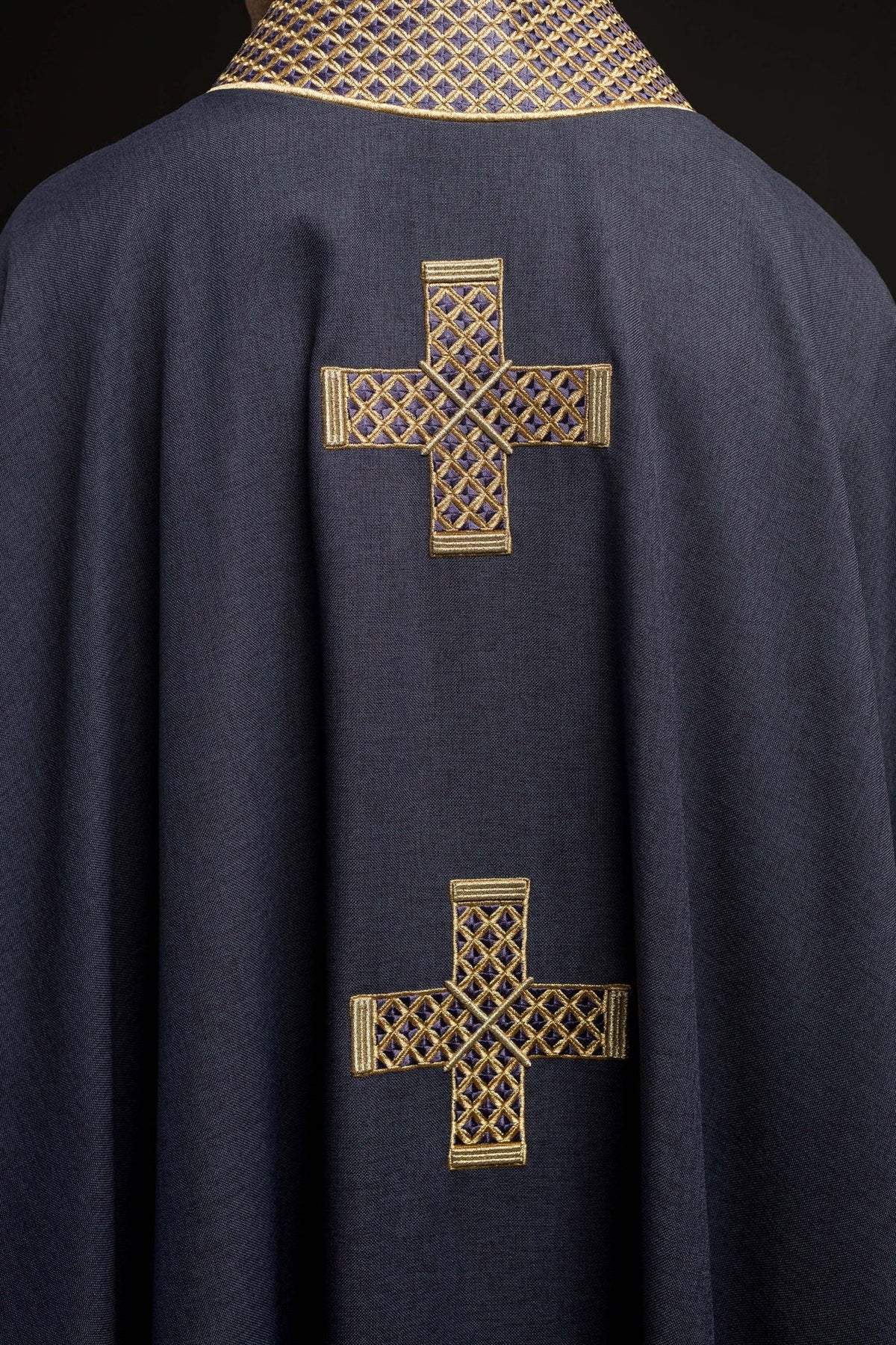 Purple chasuble back detail with two gold embroidered crosses