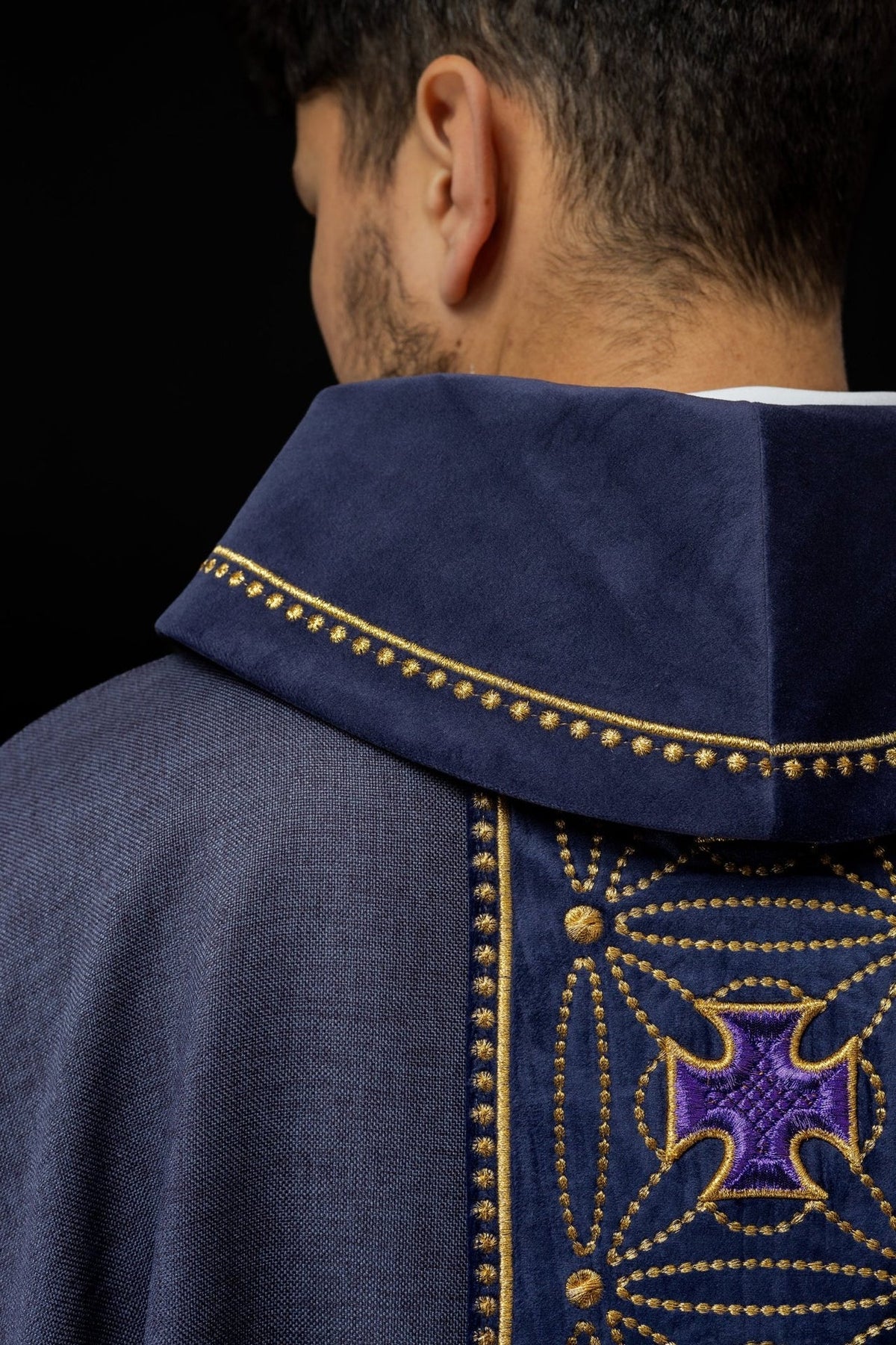 Purple chasuble collar close-up with gold embroidered trim