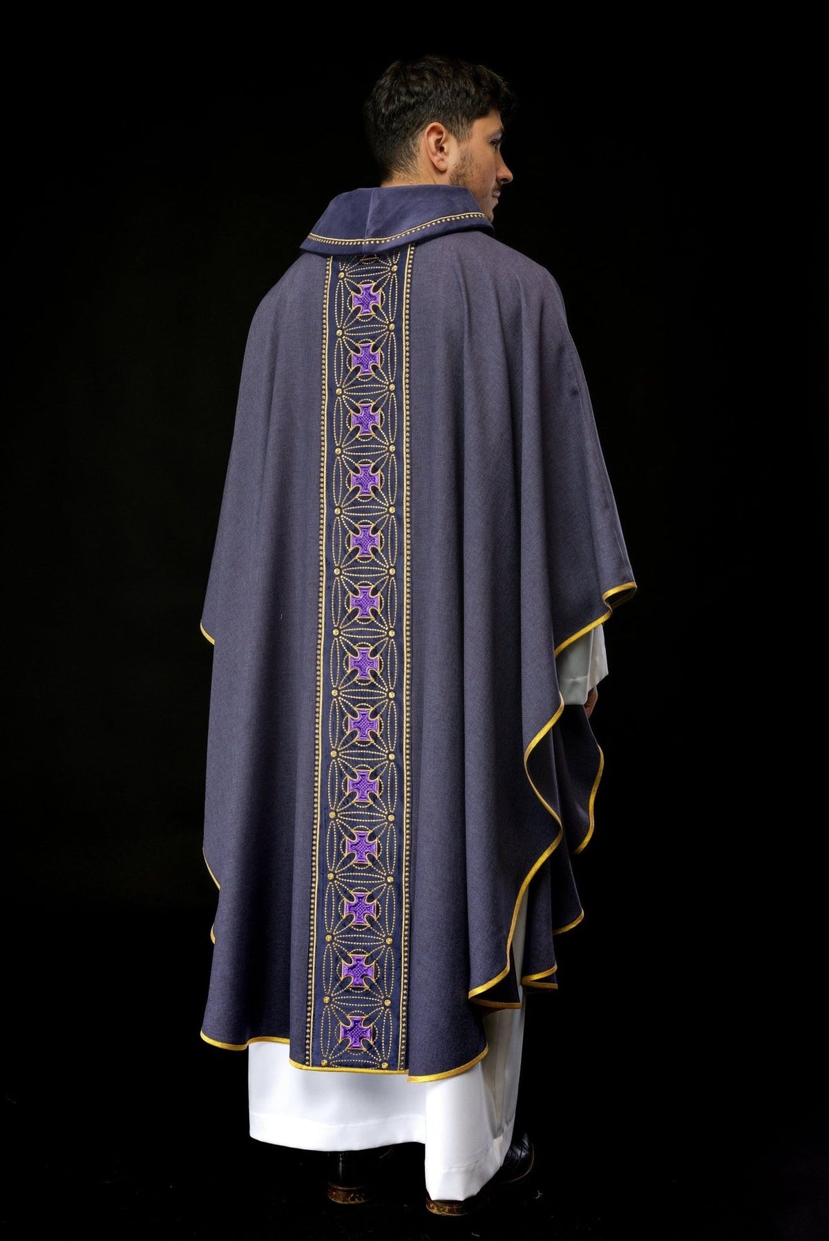 Purple chasuble rear view showing gold-trimmed orphrey and crosses