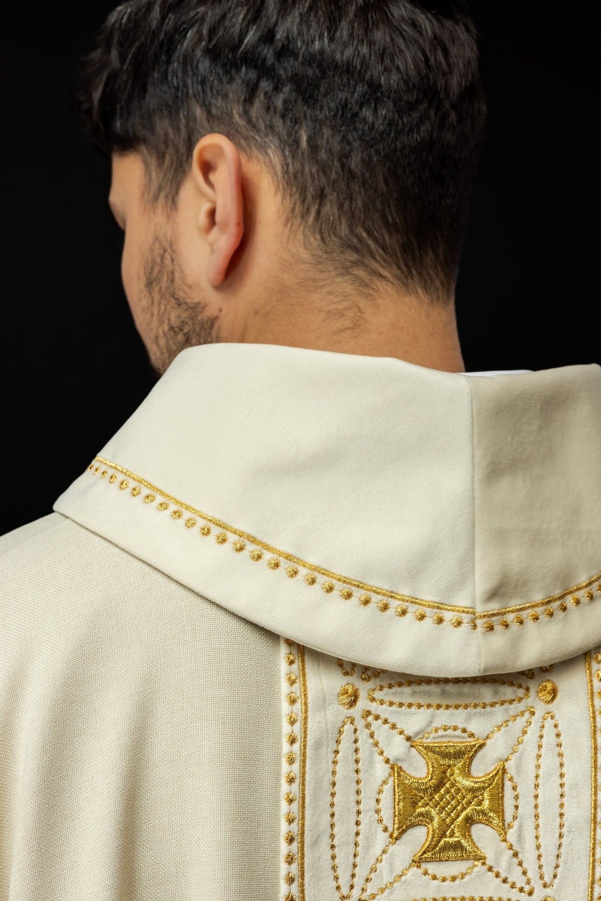 Ecru chasuble detail showing gold embroidered cross orphrey and trim