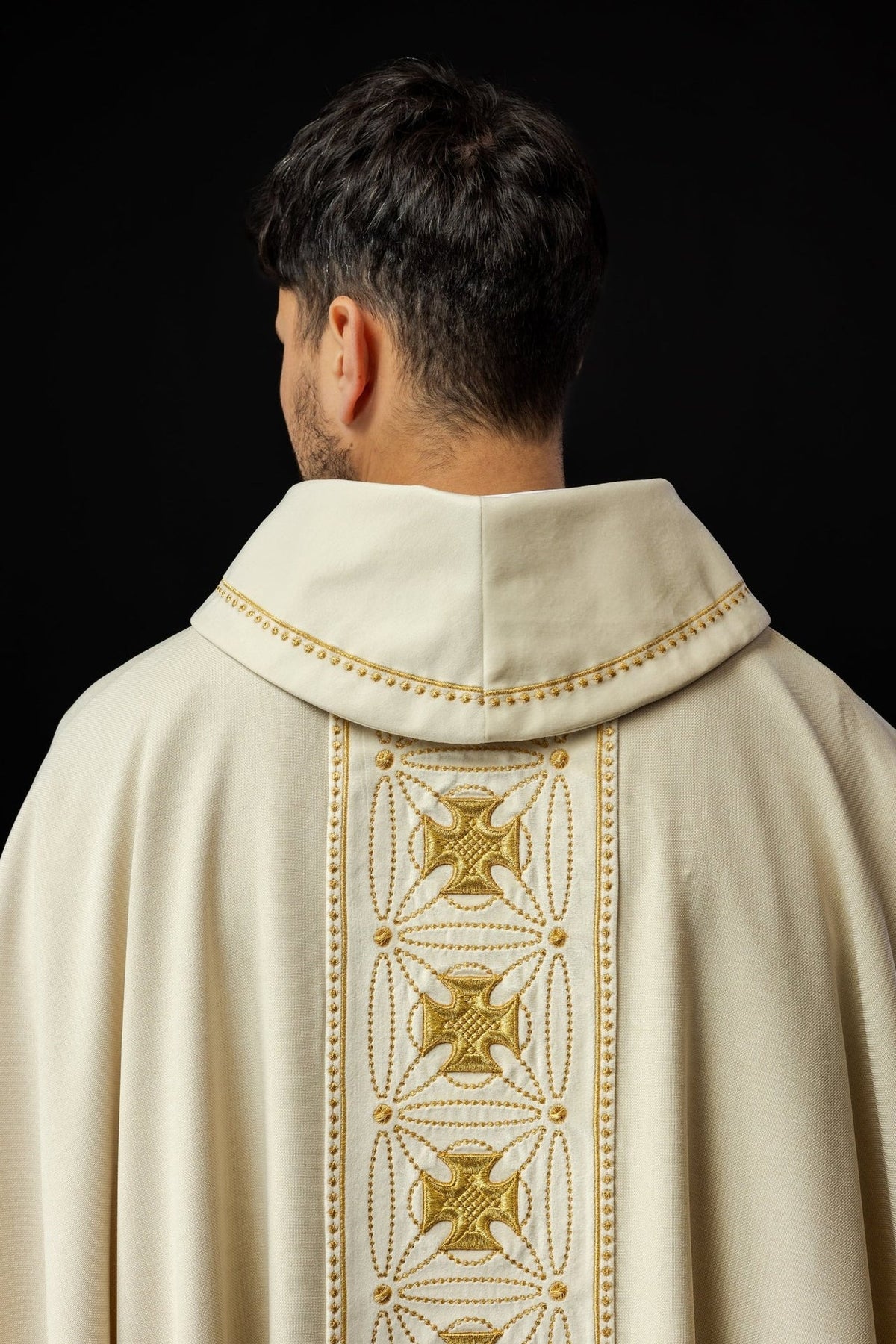 Ecru chasuble back close-up with gold embroidered cross orphrey