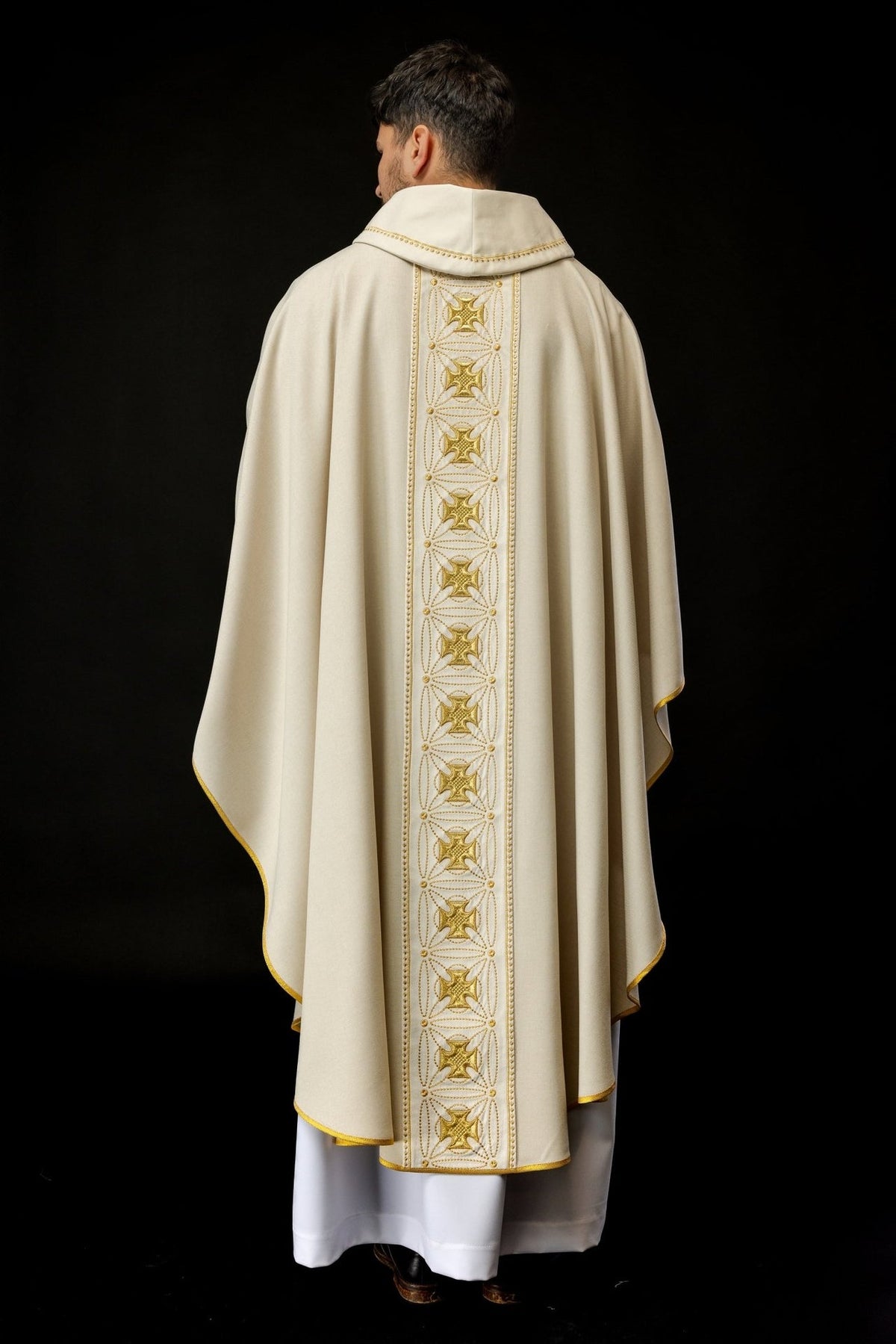 Ecru chasuble back view with a long gold embroidered cross orphrey