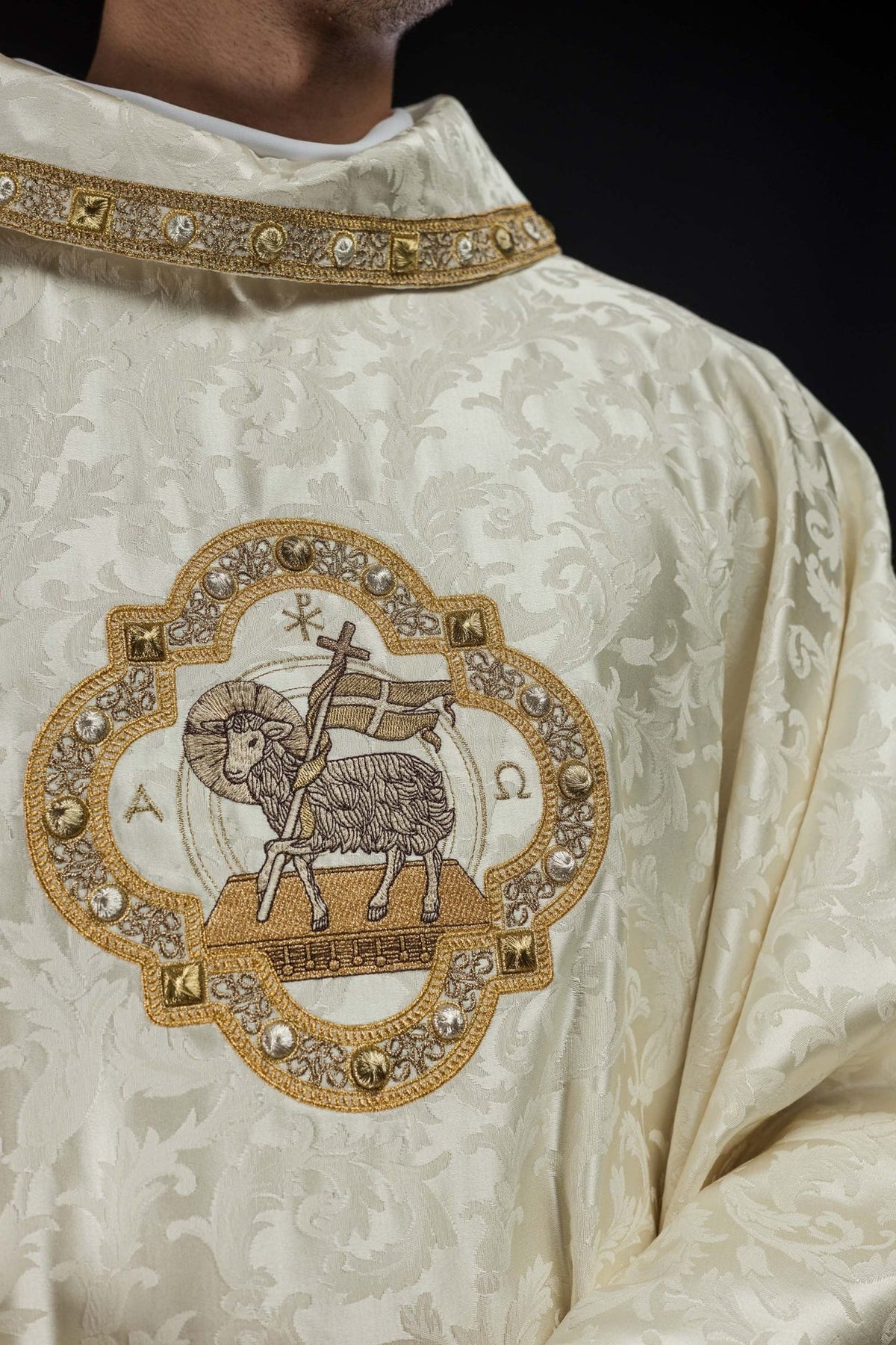 Close-up of ecru chasuble with Paschal Lamb embroidery and stand-up collar