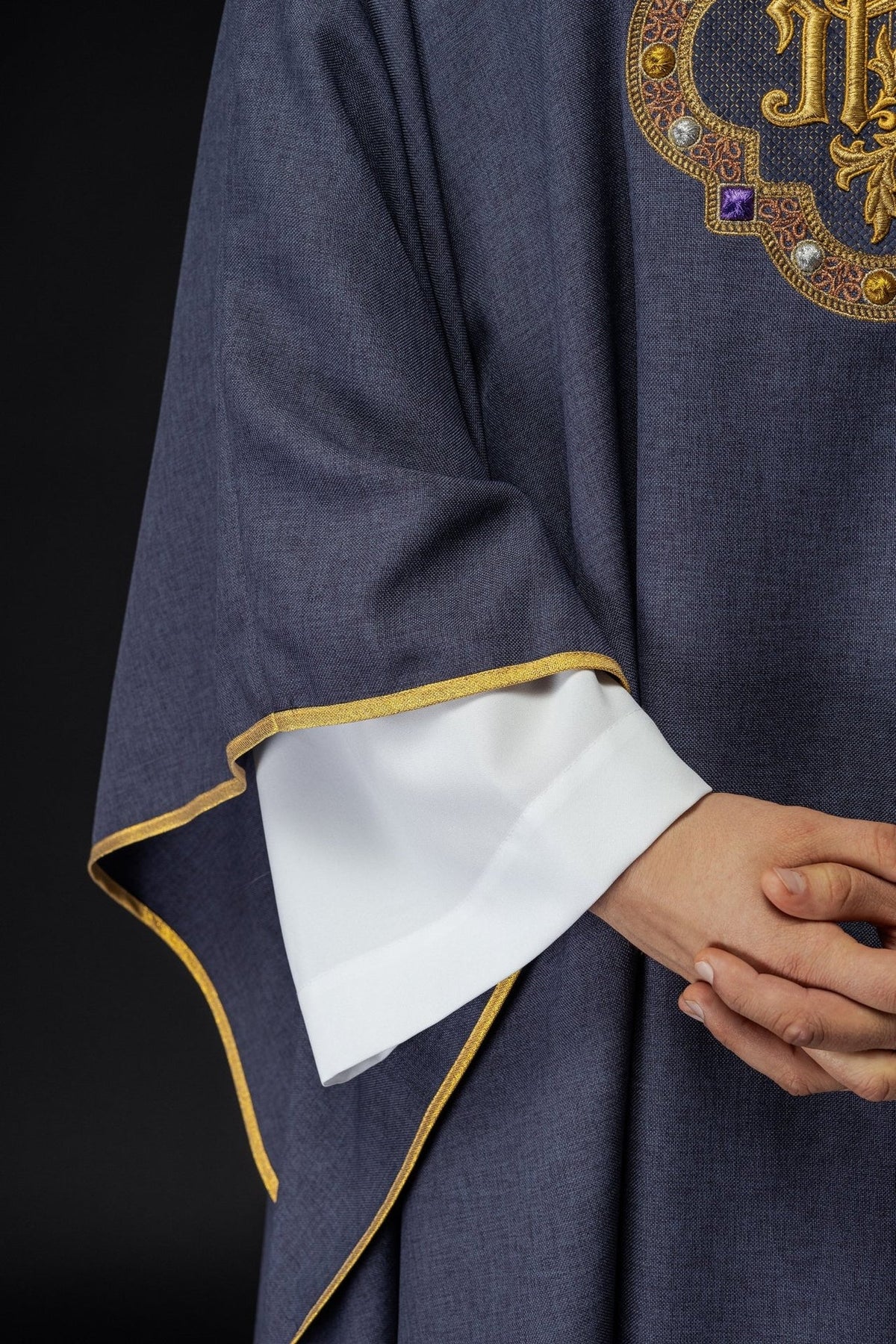 Purple chasuble close-up of IHS embroidery and sleeve trim