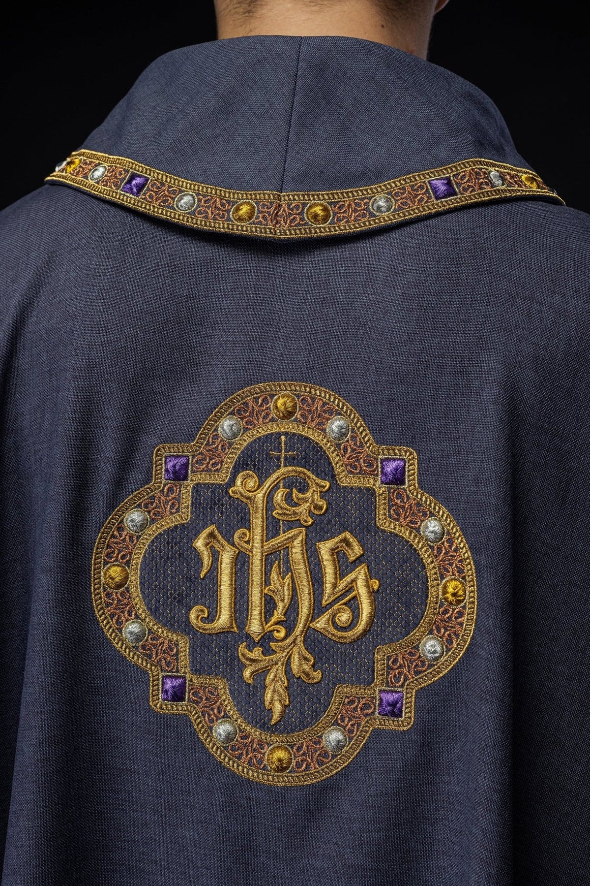 Purple chasuble side detail with gold-trimmed sleeve