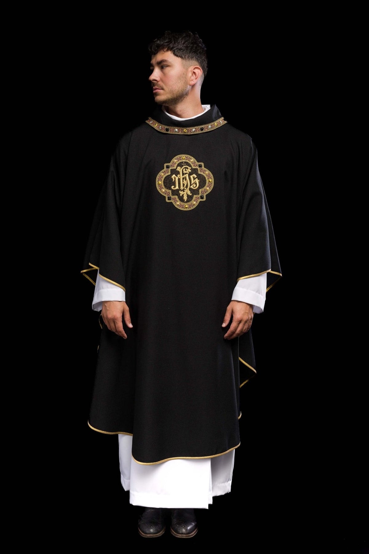 Black chasuble front view with gold trim and IHS embroidery
