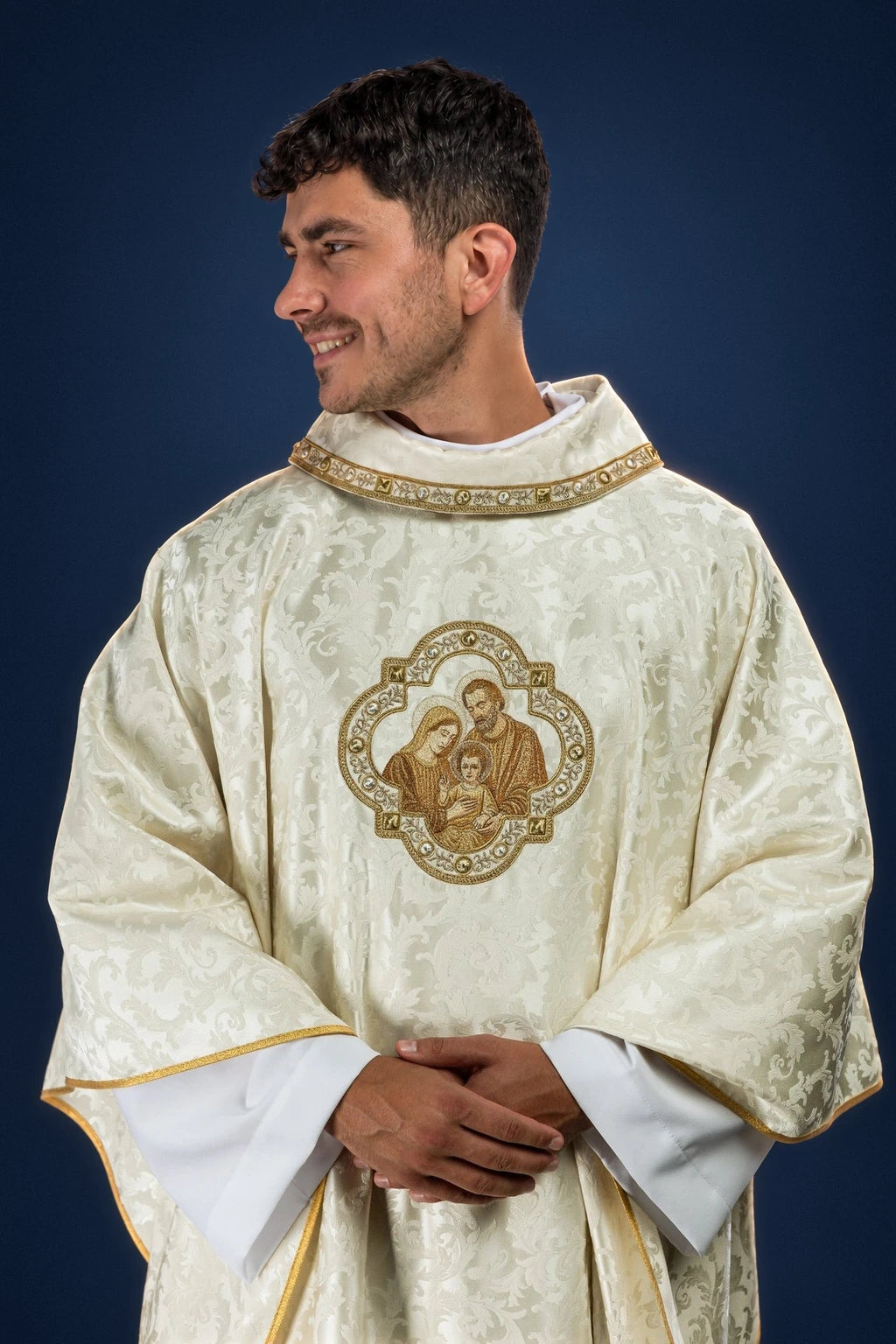 Embroidered Christmas Chasuble with an Image of the Holy Family, front view in ivory with gold trim