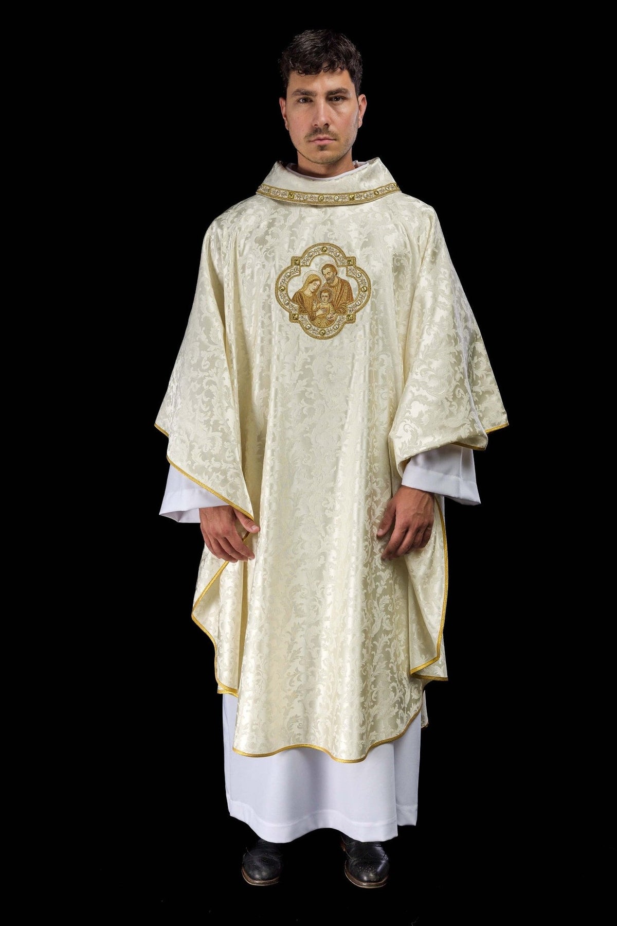 Christmas chasuble worn from the front, showing ivory damask fabric and gold trim