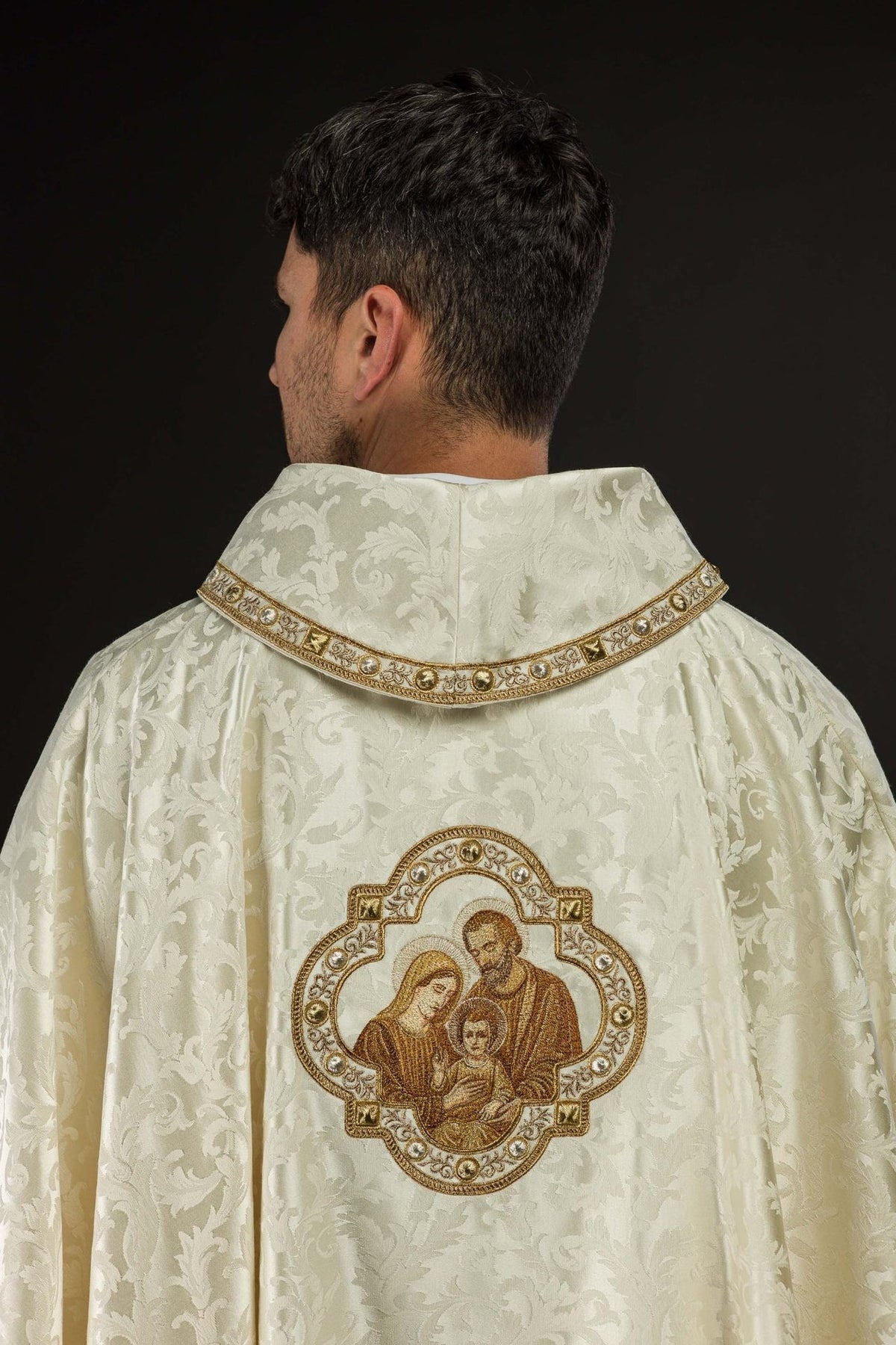 Christmas chasuble back view with Holy Family embroidery and gold-edged hem