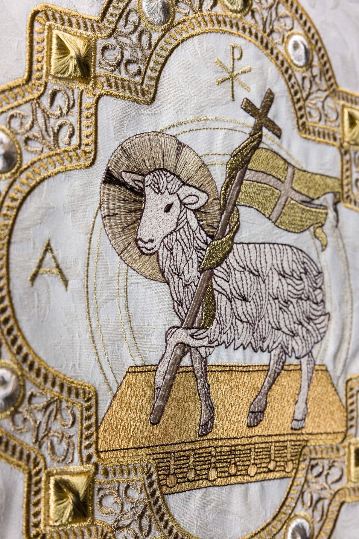 Church lectern cover close-up of the embroidered Paschal Lamb and cross