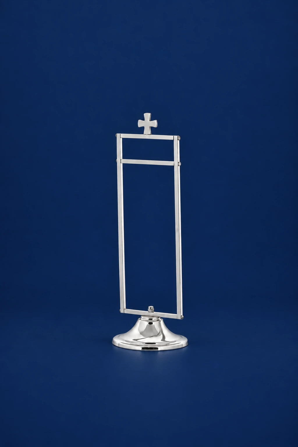 Silver-finish brass purificator holder with cross top and rectangular frame on a pedestal base, front view
