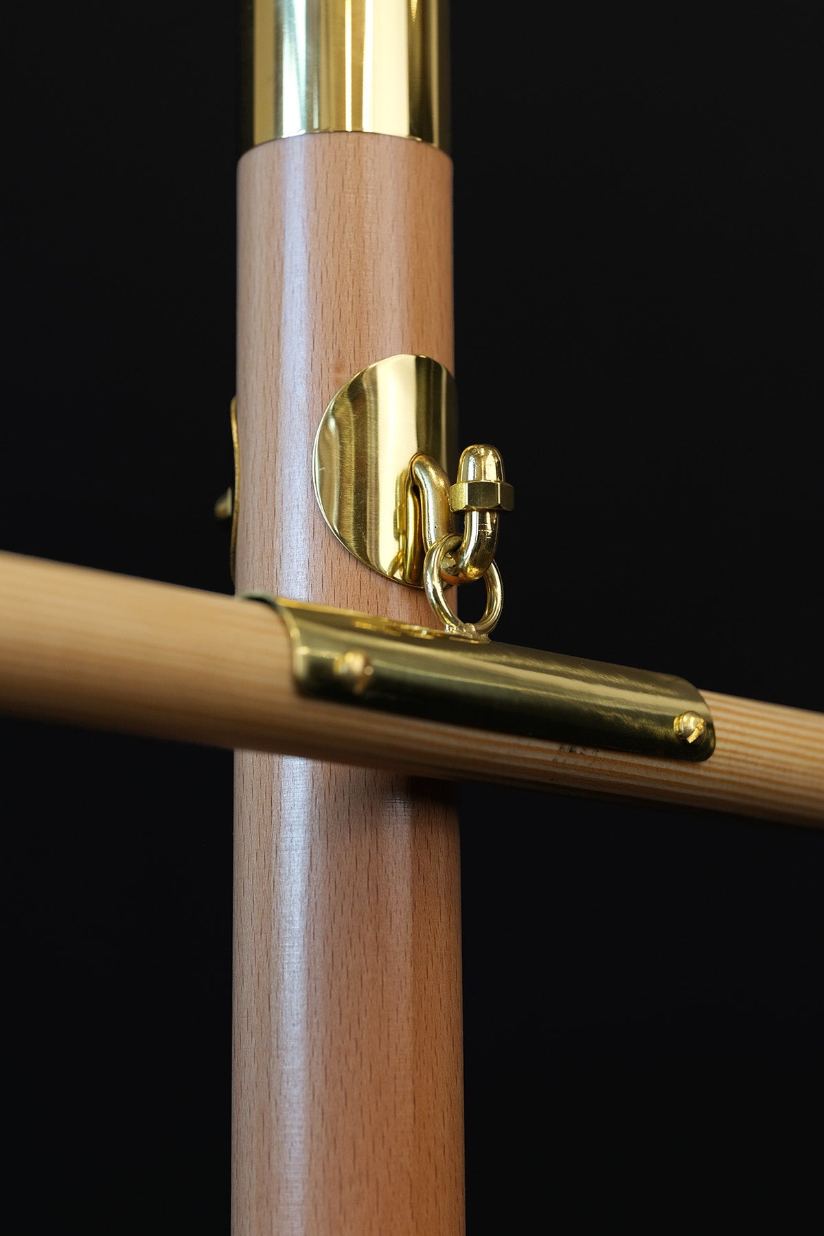 Light wood banner pole, close-up of gold banner attachment and hanging ring