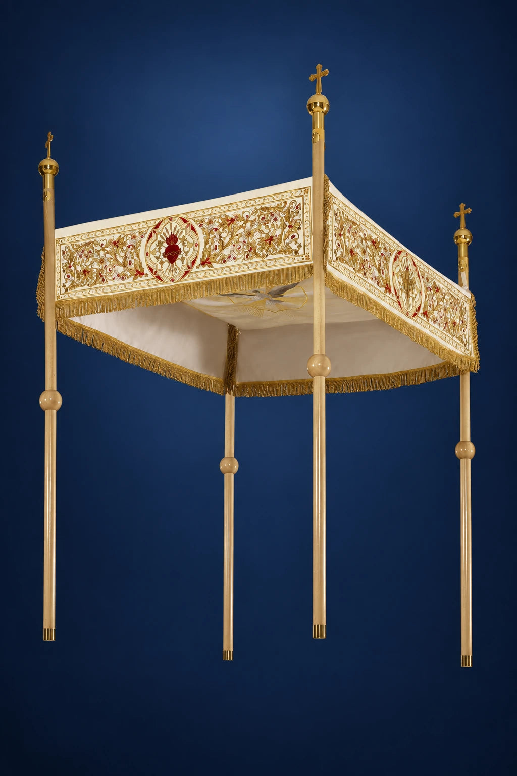 Three-quarter view of a large processional canopy with gold fringe, embroidered Chi Rho and Sacred Heart border, and four