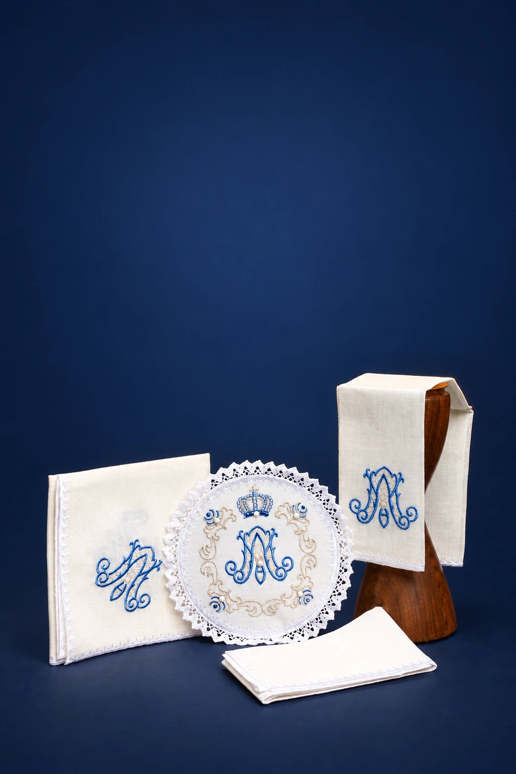 White altar linen set with blue Marian embroidery and lace-edged round purificator