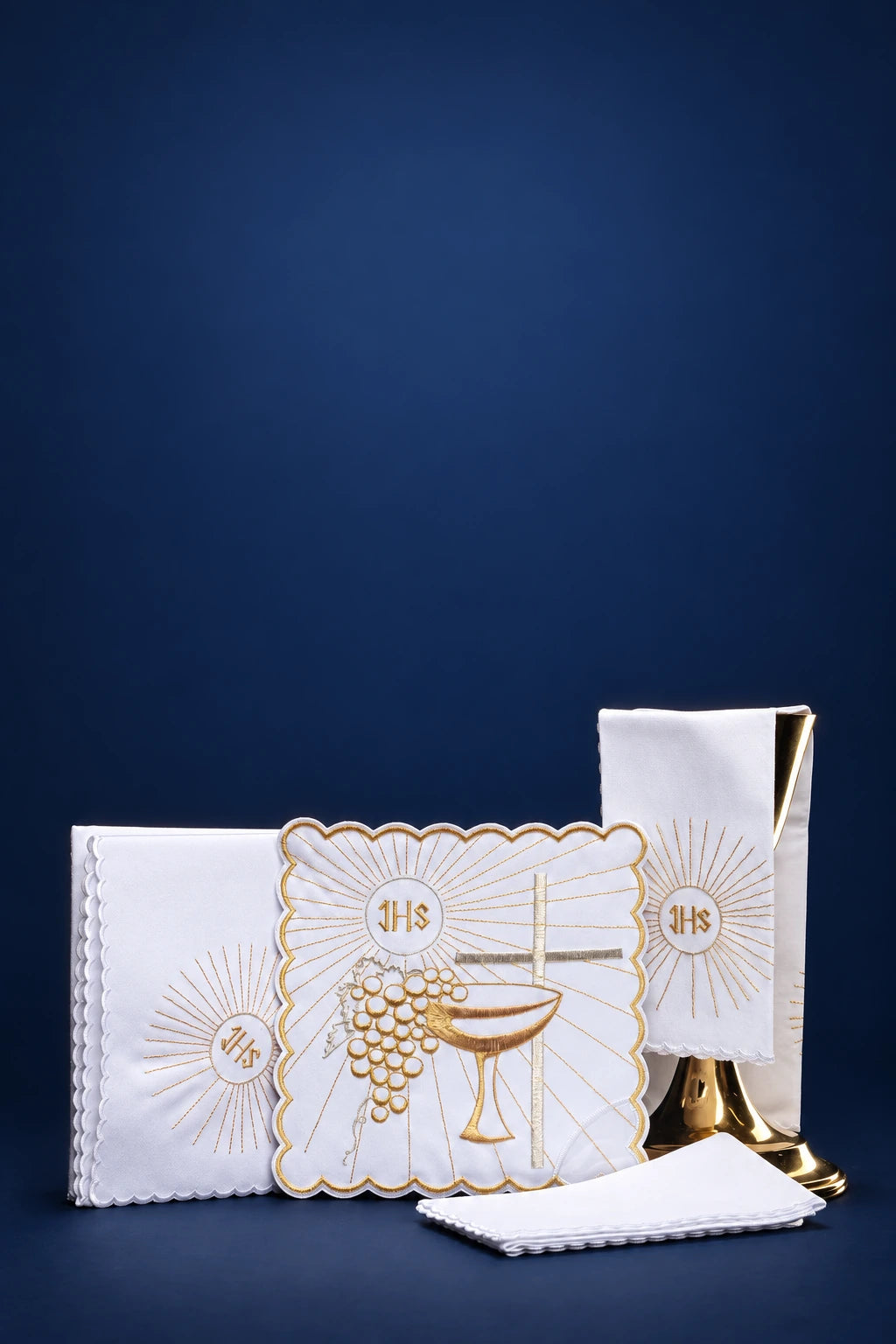 White altar linen set with chalice, grapes, and IHS embroidery, shown folded with a small cloth in front