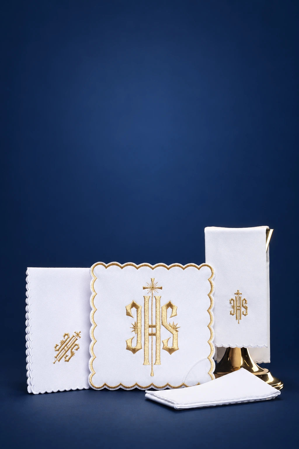 White altar linen set with scalloped gold trim and IHS embroidery, shown folded front view